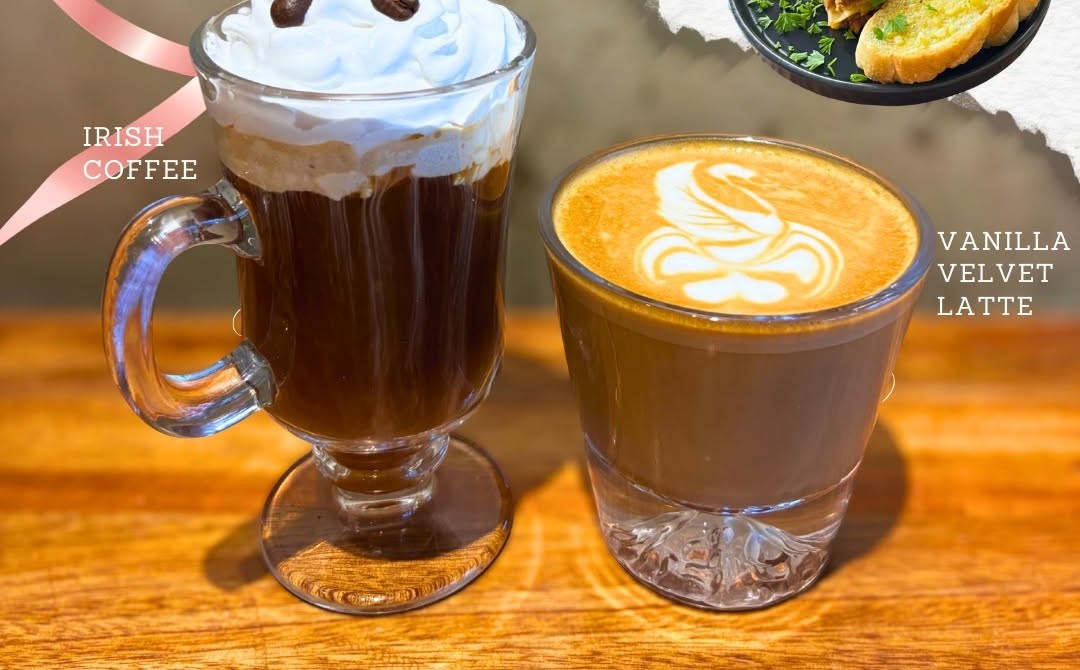 Irish coffee and a vanilla velvet latte on a wooden table.